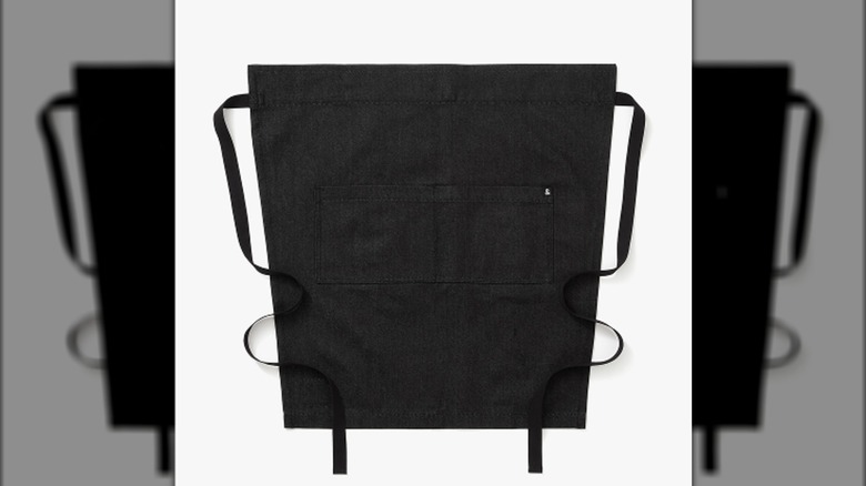A black bistro apron on a white background