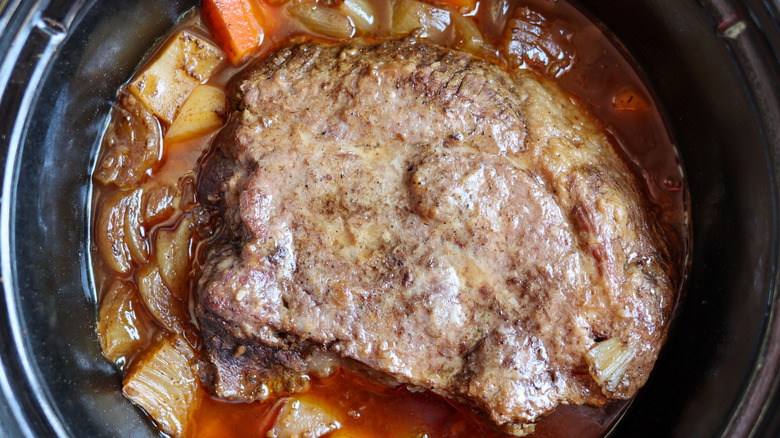 homemade pot roast cooking in liquid