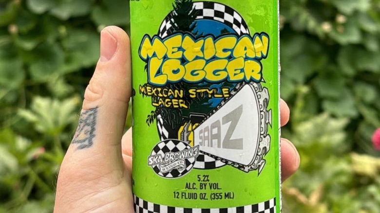 Hand holding a can of Ska Brewing Mexican Lager Mexican-Style Lager