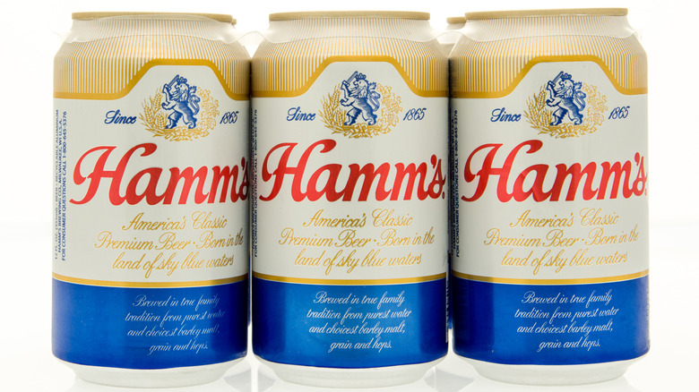 Three cans of Hamm's beer on a white background