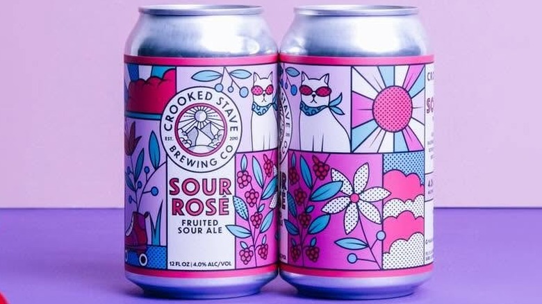 Two cans of Crooked Stave Sour Rosé on a purple background