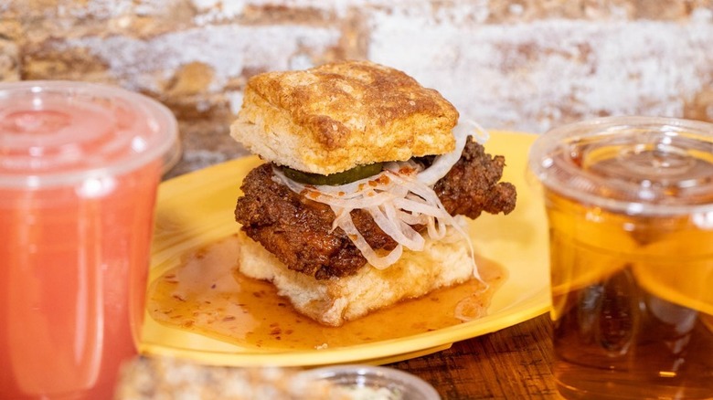 A fried chicken biscuit sandwich on a plate at Harlem Biscuit Company