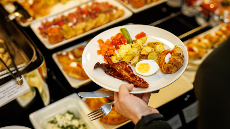 A person holding a breakfast plate at a Las Vegas buffet