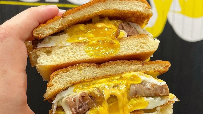 A person holding The Banker sandwich at The Tasty Yolk in Connecticut