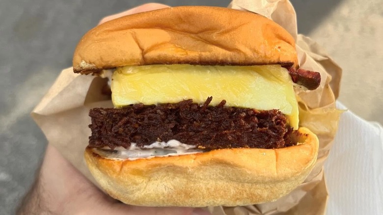 A person holding a Breakfast Sandwich at Allez Cafe in Chicago