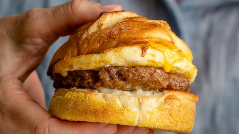 A person holding a Breakfast Sandwich at La Boulangerie in New Orleans