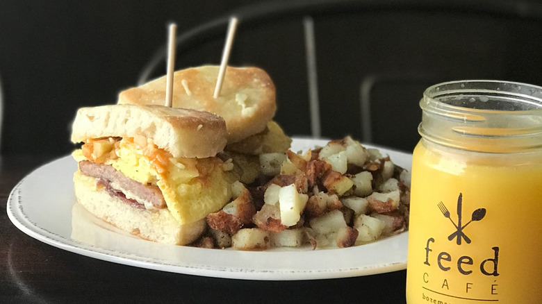 The Bapple breakfast sandwich with hash browns and a juice at Feed Cafe in Bozeman