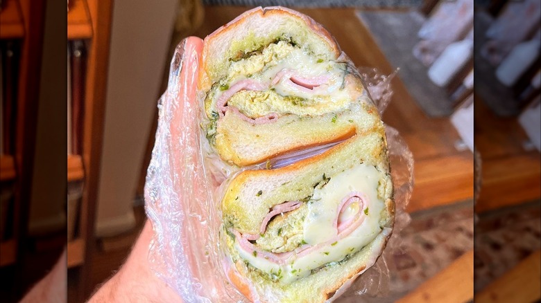 A person holding a Green Eggs & Ham sandwich at Brancaccio's Food Shop in New York City