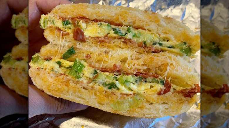 A person holding a Breakfast Torta at Laurel Market in Charlotte