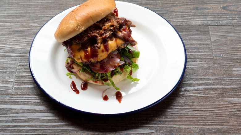 Burnt ends burger on a white plate