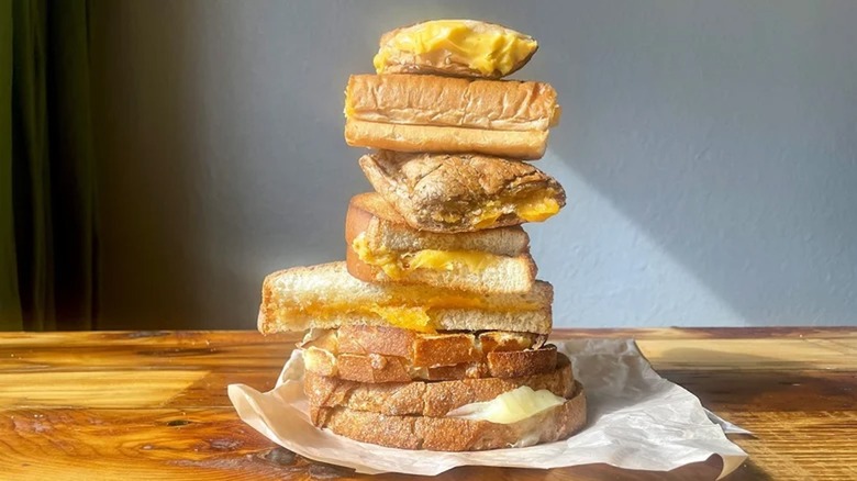 A stack of grilled cheese sandwiches from various chain restaurants