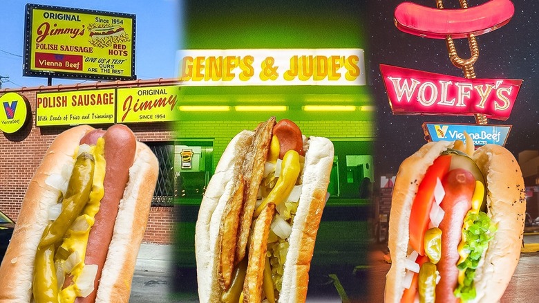 An image of three Chicago style hotdogs with hot dog joints in the background