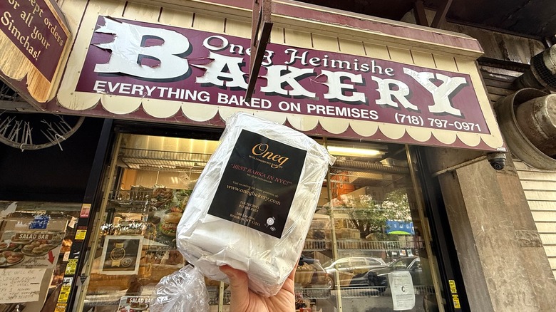 holding a babka outside of Oneg Bakery
