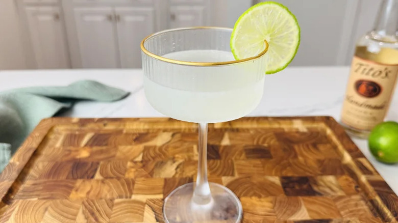 Close up of vodka gimlet in gold-rimmed glass