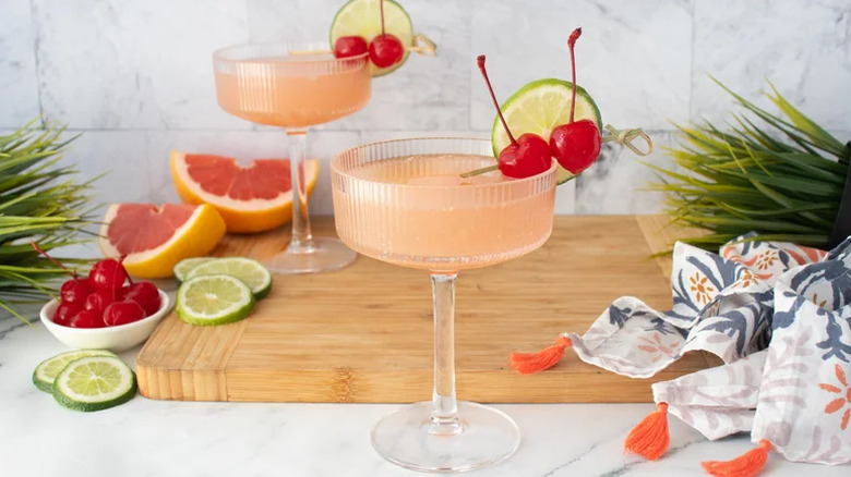Two glasses of Hemingway daiquiri with lime and cherry garnish