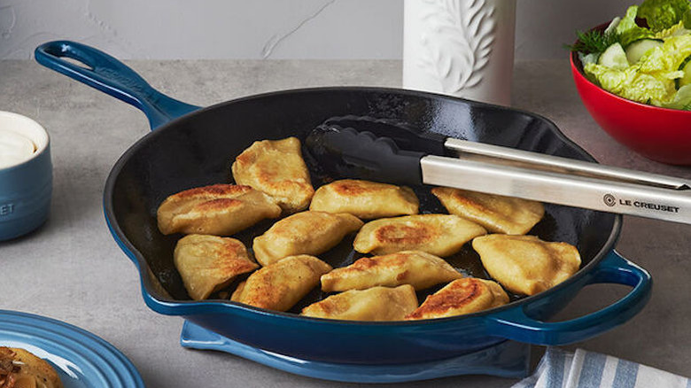 food and tong in pan