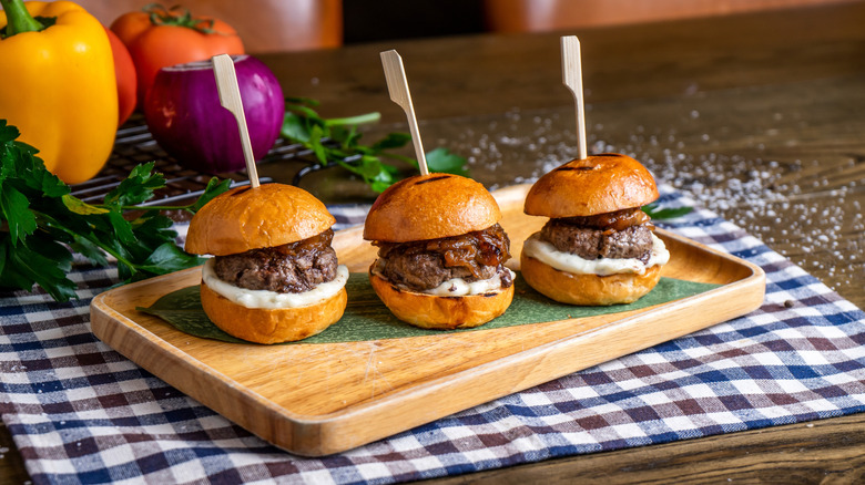 burger sliders on a wooden tray