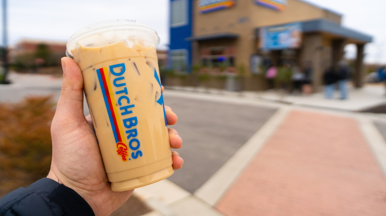Hand holding Dutch Bros coffee