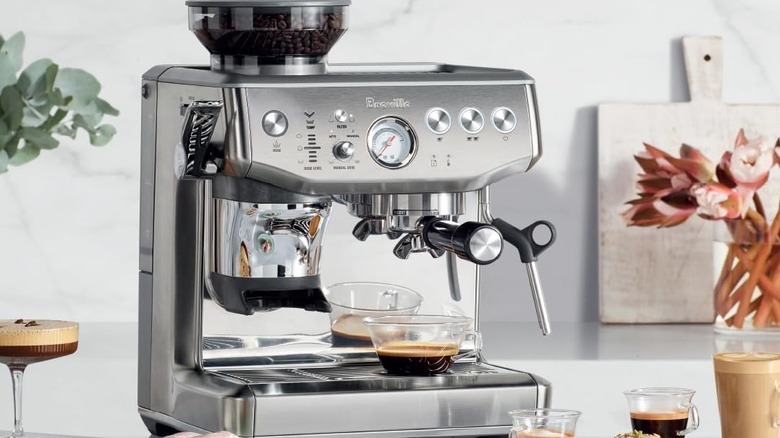 Breville Barista Express Impress Machine on white kitchen counter