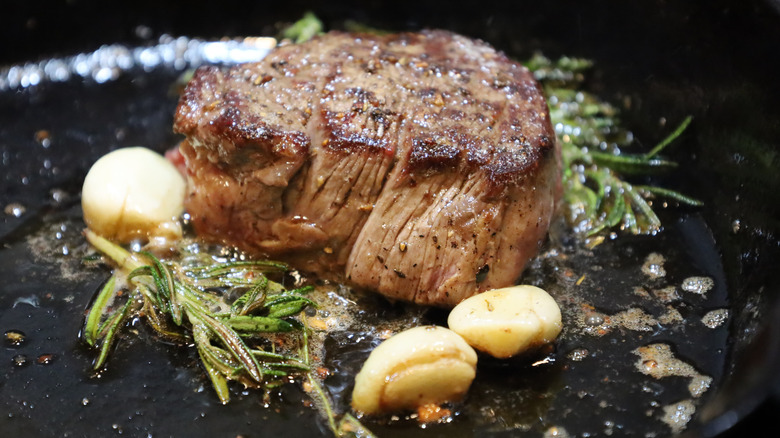 Seared filet mignon with herb butter.