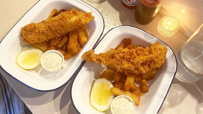 Two plates of fish and chips at Dame