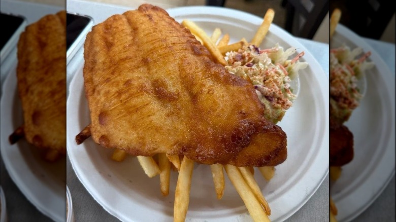 A plate of fish and chips with coleslaw at Sir Cricket's Fish and Chips