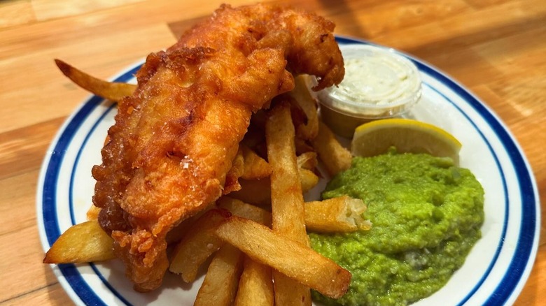 A plate of fish and chips with mushy peas at Stargazy