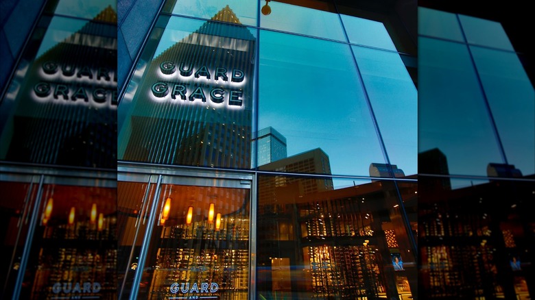 The exterior of Guard and Grace restaurant with the skyline reflected