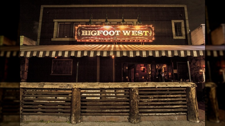 The exterior of Bigfoot West, a rustic cabin-style building made of recycled wood