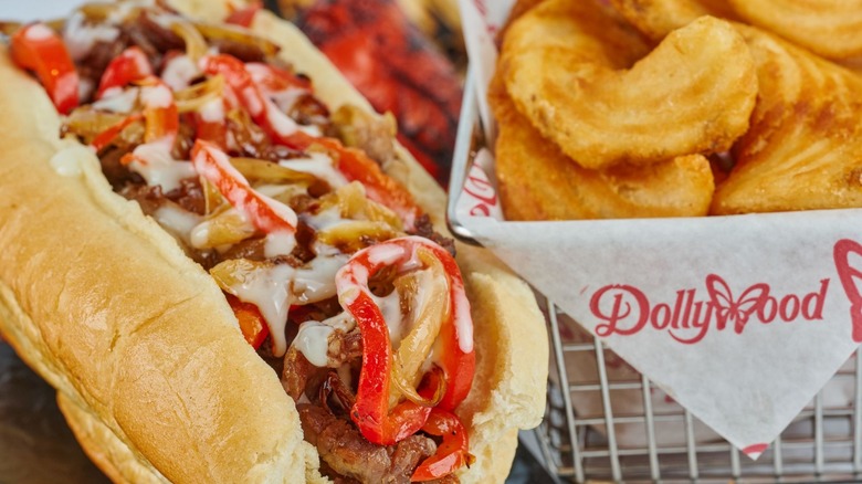 A large hoagie-style sandwich with brisket, red and green peppers, and melted Provolone cheese.