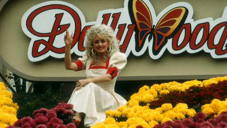 Singer Dolly Parton sits at the entrance to Dollywood in 1988.