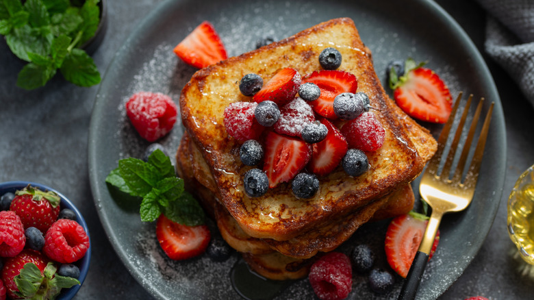 Plate of French toast with berries and syrup