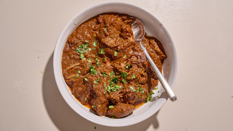 bowl of chicken mole on a table