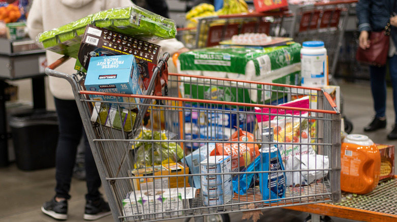 A shopping cart filled with groceries in a store