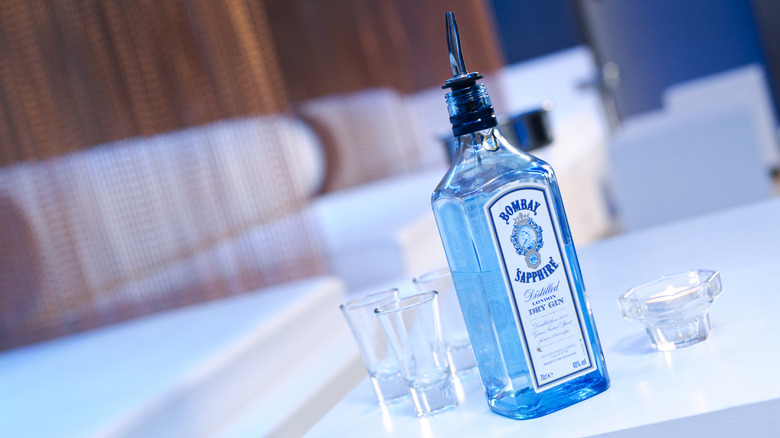 Bottle of Bacardi Limited Star of Bombay Gin with various cocktail making equipment