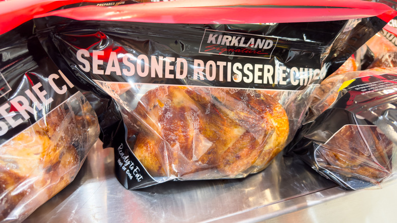 Bags of Kirkland rotisserie chicken on a metal counter
