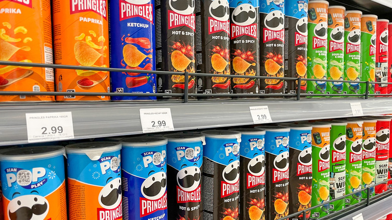 Pringles cans lined up on a shelf at a grocery store