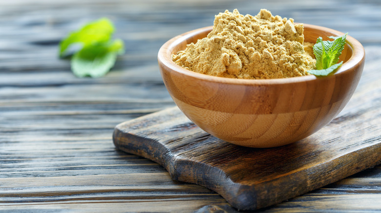 Wooden bowl filled with mustard powder