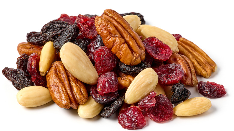 a mixture of dried fruit and nuts on a white background