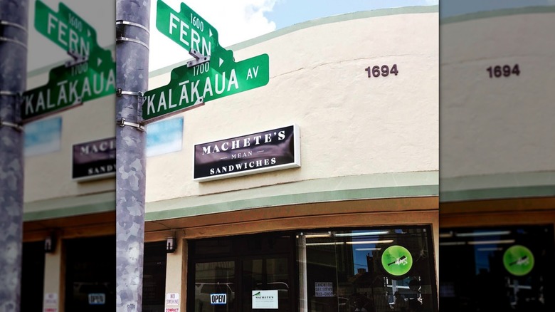 Exterior of Machete's Mean Sandwiches with street sign in frame