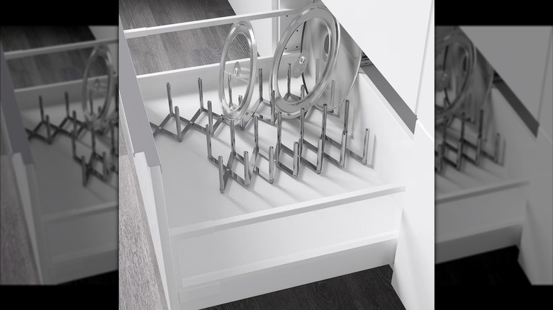 Metal pot lid organizer in kitchen drawer