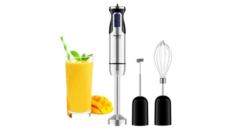 Mueller immersion blender on white background next to a smoothie