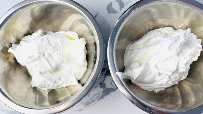 whipped cream in two metal bowls