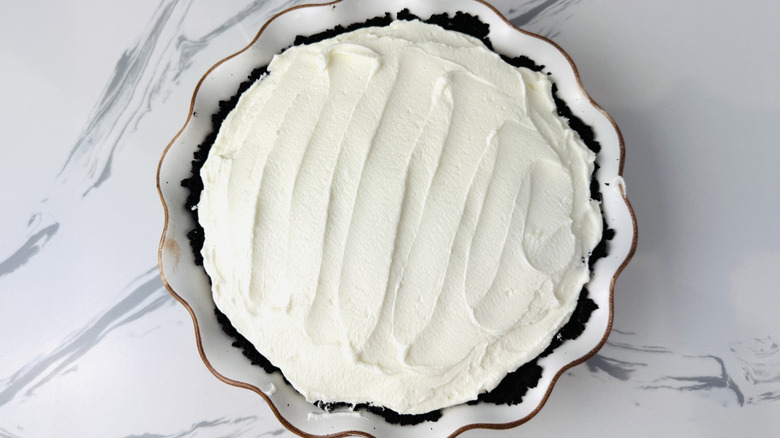 white cream pie with a chocolate crumb crust