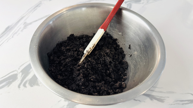 chocolate cookie crumbs in a metal bowl