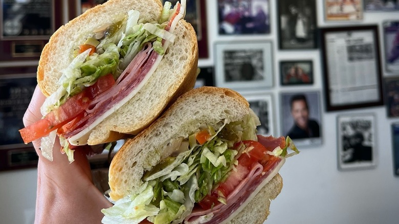 A person holding a sandwich at Bari Foods in Chicago