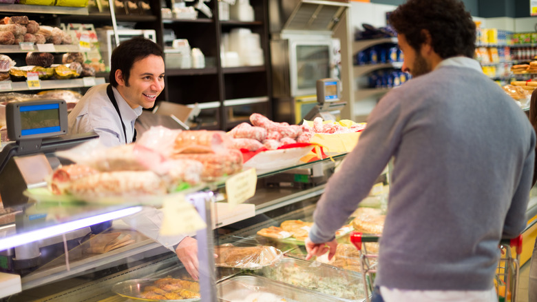 A person shopping at an Italian deli