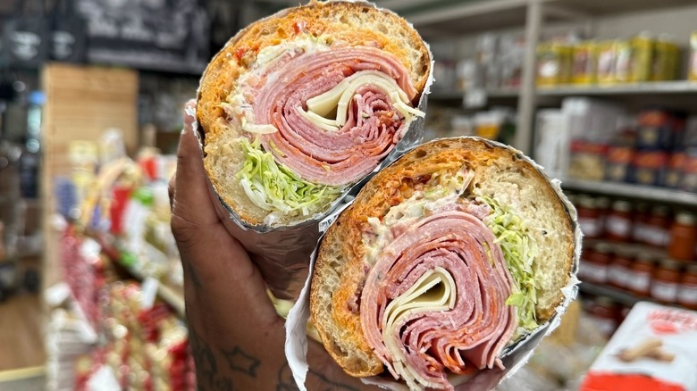 A person holding an Italian sub at Trinacria in Baltimore