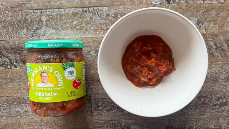 a white bowl and jar of Newman's Own chunky mild salsa