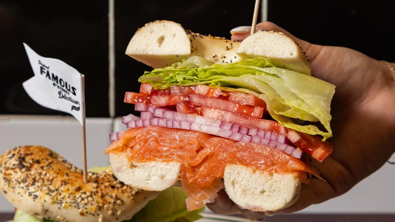 A person holding a bagel with Nova lox at 4th Street Delicatessen in Philadelphia